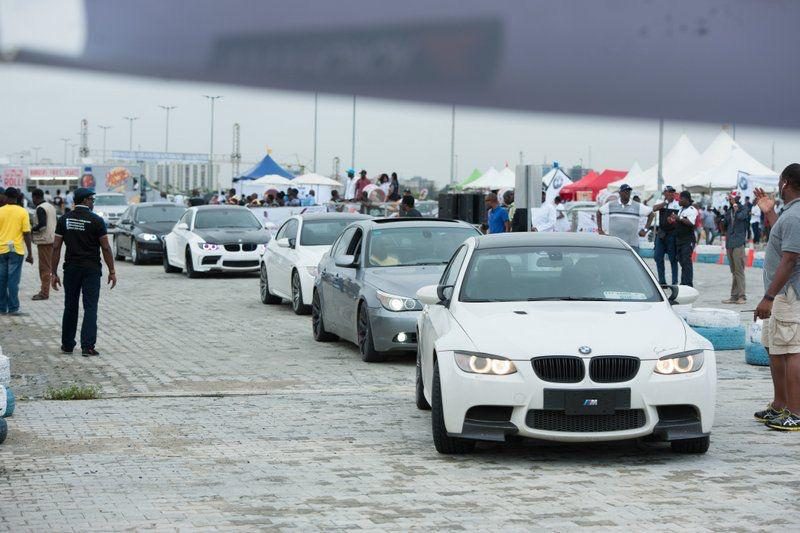BMWs lined up by the water